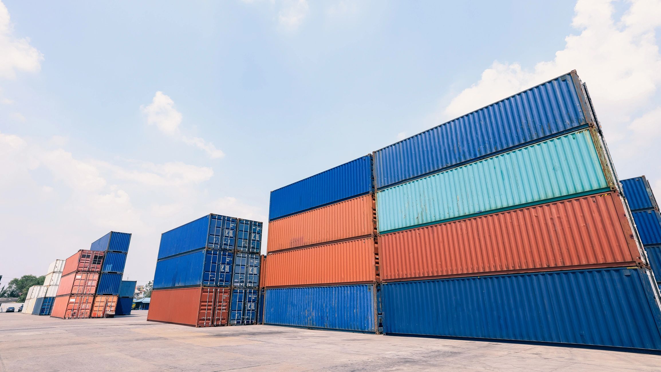 Stacked shipping containers at a cargo yard for export logistics
